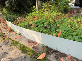 A ANLEOLIFE 40-inch border in white adds durable pathway edging.