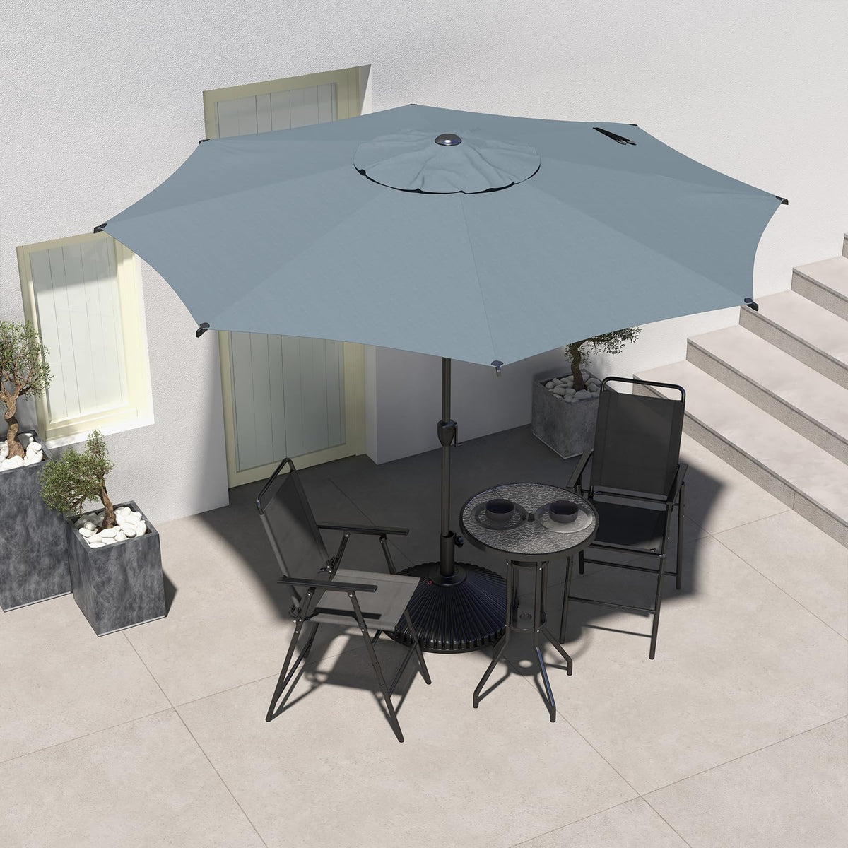 Abba Patio Lyon umbrella in garden setting provides broad shade and comfort.