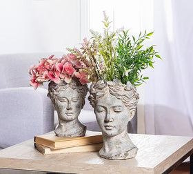Goddess Head Planter in garden setting, Abbott Collection, large grey display.