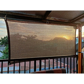 Abrotain fence privacy screen on deck provides breathable shade for outdoor seating.