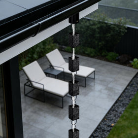 Adorafur rain chains styled as a garden feature during rainfall