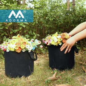 ADORMA 12-pack 15 gallon grow bag in garden ready for versatile planting.