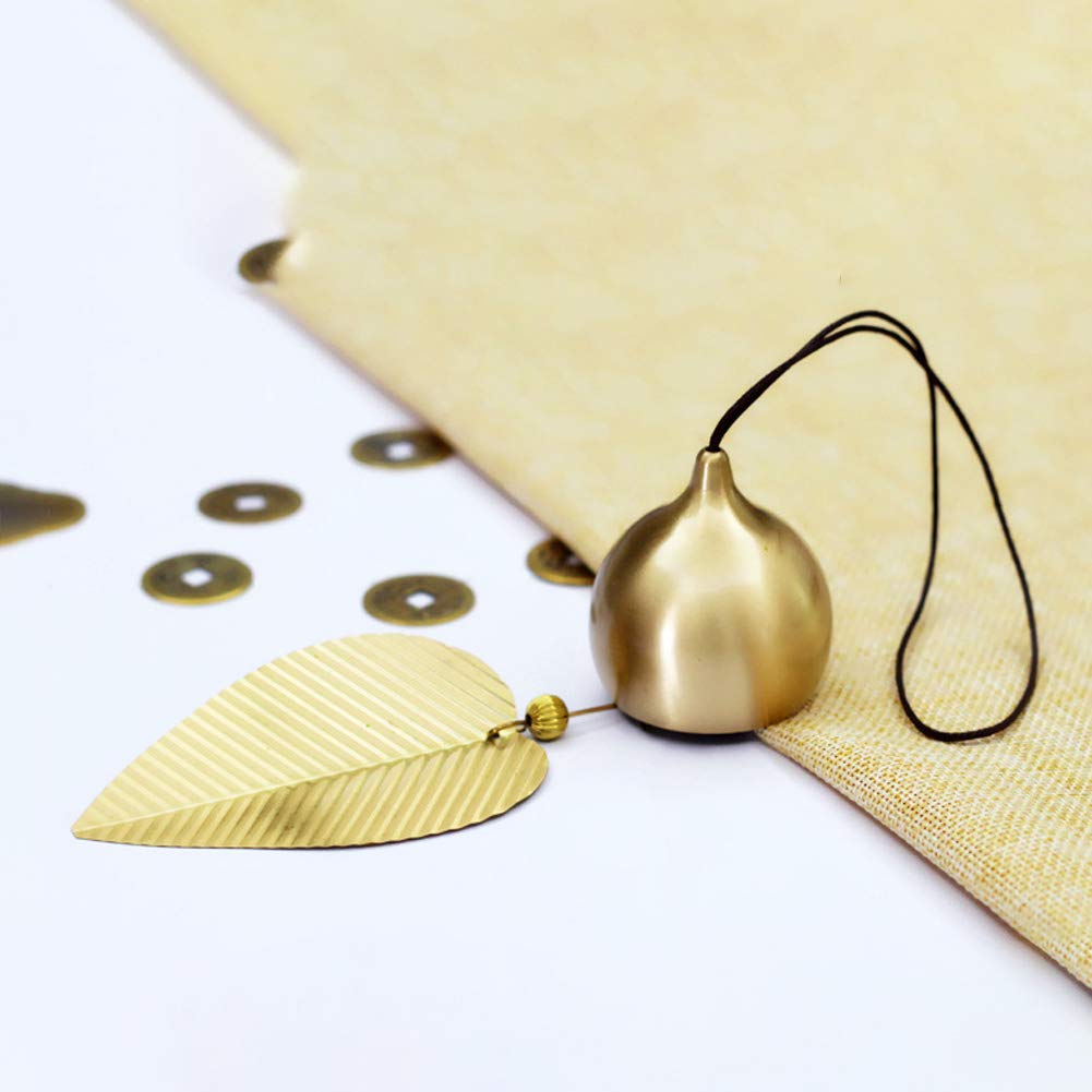 Afiaiwei gold leaf bell hangs in the garden as décor.