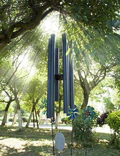 Afirst 66-inch wind chimes over a sunny patio, promoting calm ambience.