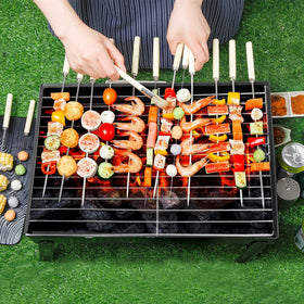 AGM Outdoor Grill on a camping scene for smoky outdoor cooking