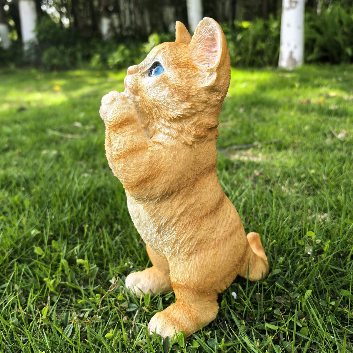 Ahbuohe garden cat statue, on patio, weather-resistant resin for year-round outdoors.