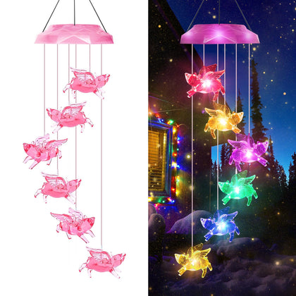 AIONASA pink fly pig wind chime glows with color-changing LEDs outdoors.