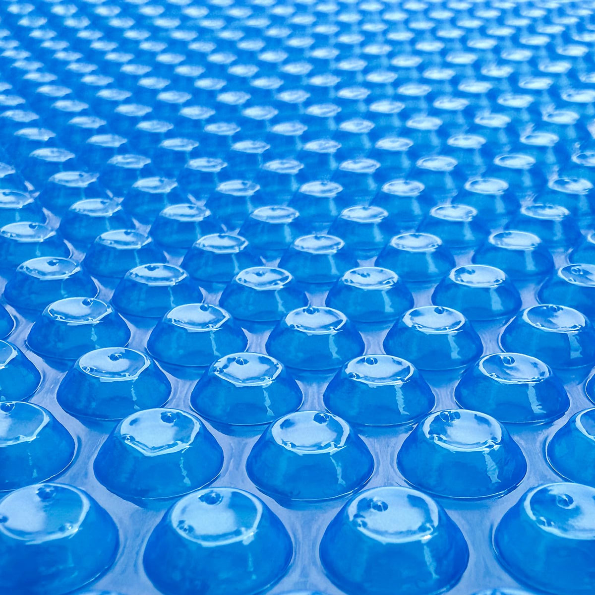Allaren solar pool cover with blue bubbles over water trapping heat for longer swims