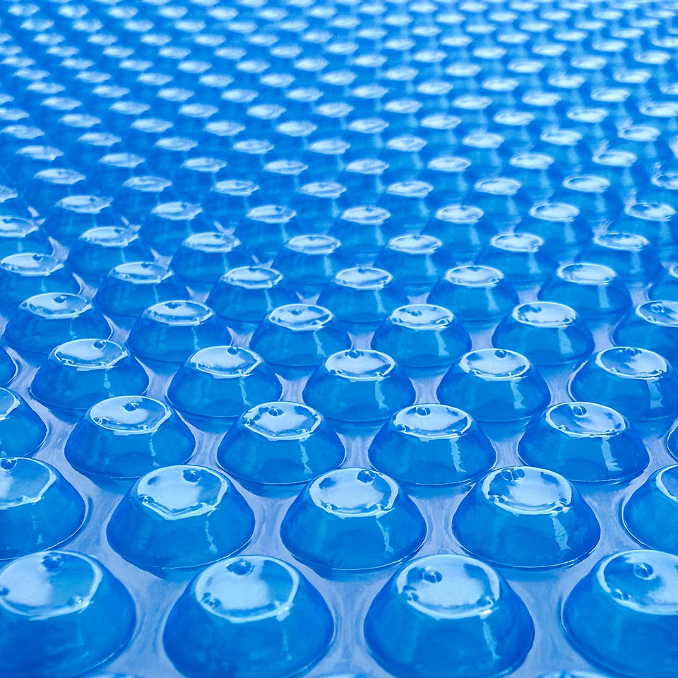 Allaren solar pool cover with blue bubbles over water trapping heat for longer swims