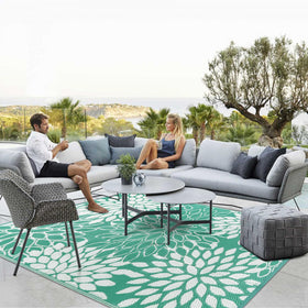 Anidaroel 8x10ft outdoor rug on patio with tropical leaves adds inviting ambiance.
