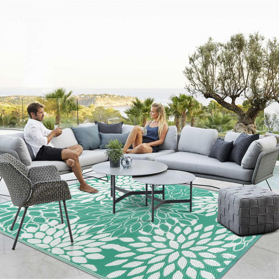 Anidaroel 8x10ft outdoor rug on patio with tropical leaves adds inviting ambiance.