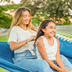 ANOW detachable pillow on blue hammock for enhanced porch relaxation.