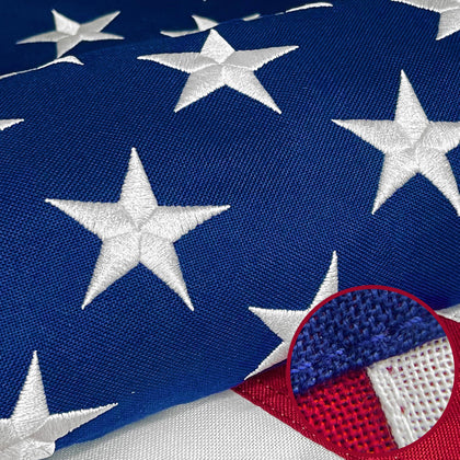 ApexFlutter American flag outdoors with embroidered stars on rich fabric near the pole