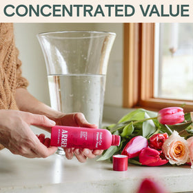 Side-by-side image of ARBER bottle with fresh stems in water