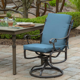 Arden Selections cushion placed on a deck chair for outdoor dining.