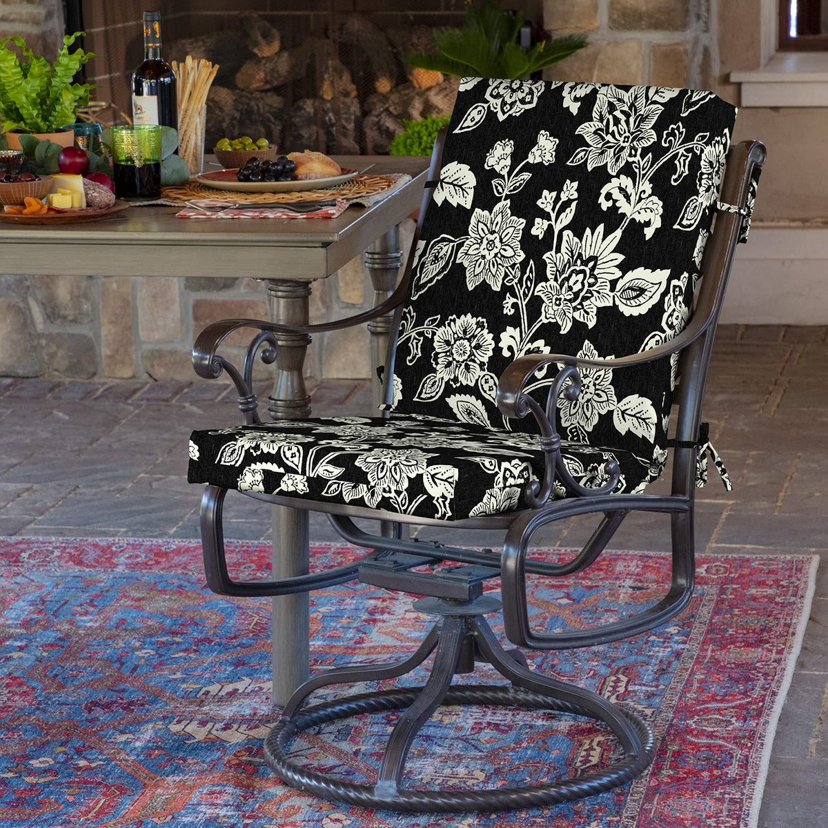 Arden Selections Ashland Black Jacobean chair cushion, side view on a patio chair.