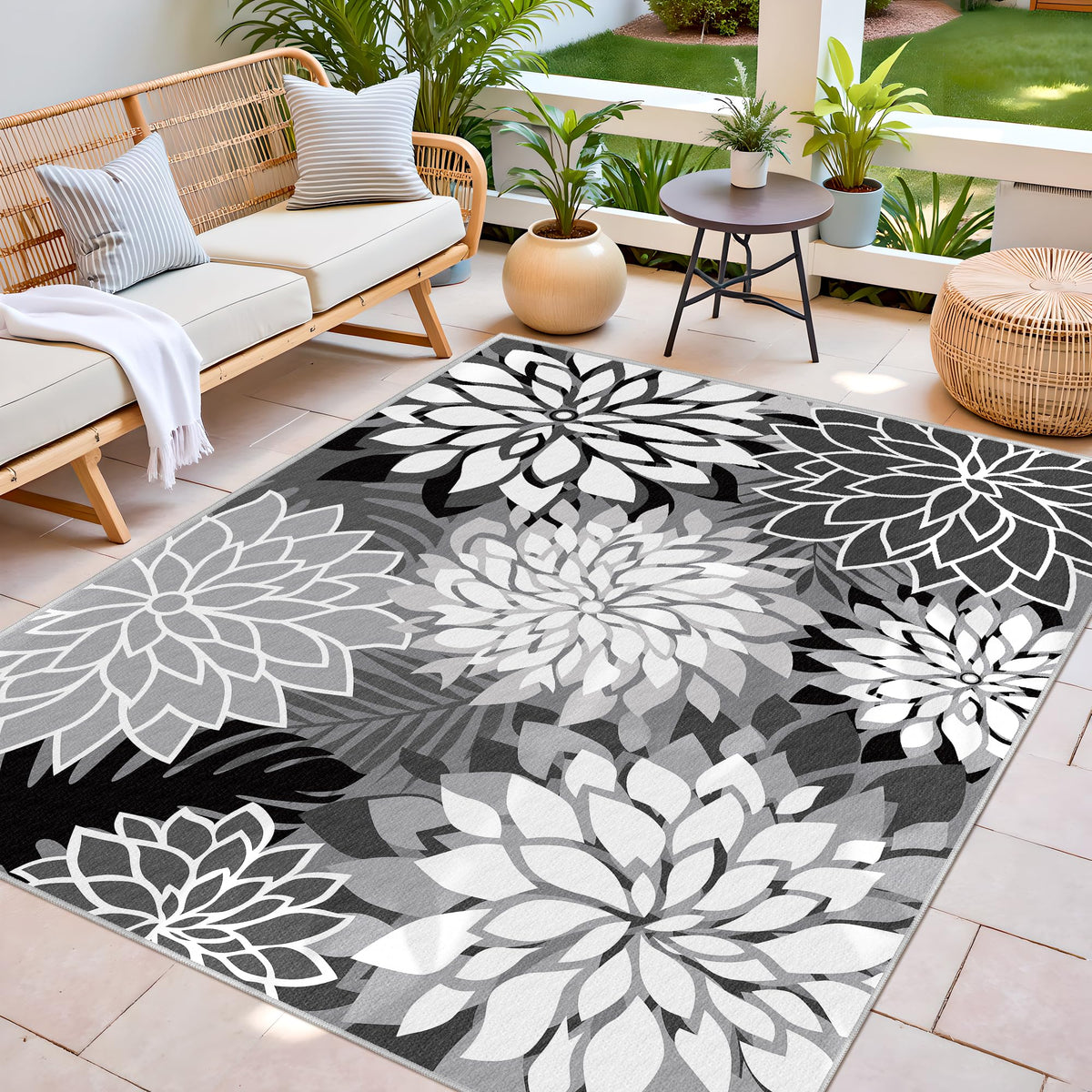 Arenarug washable outdoor rug being rinsed with hose shows easy cleanup