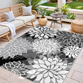 Arenarug washable outdoor rug being rinsed with hose shows easy cleanup