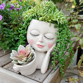ASDFG face pot with dual openings for vibrant indoor plants.