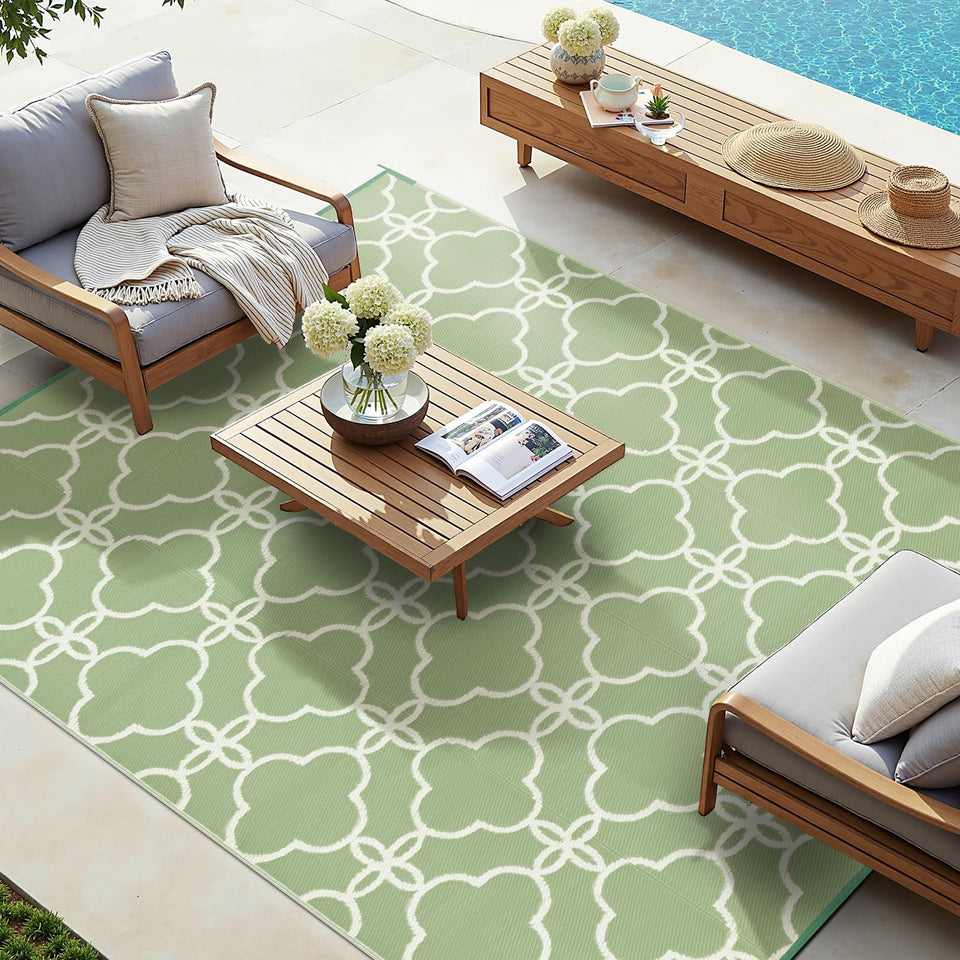 Ashler Home Deco outdoor rug sage green 5x8 on patio, weather-resistant design for year-round use.