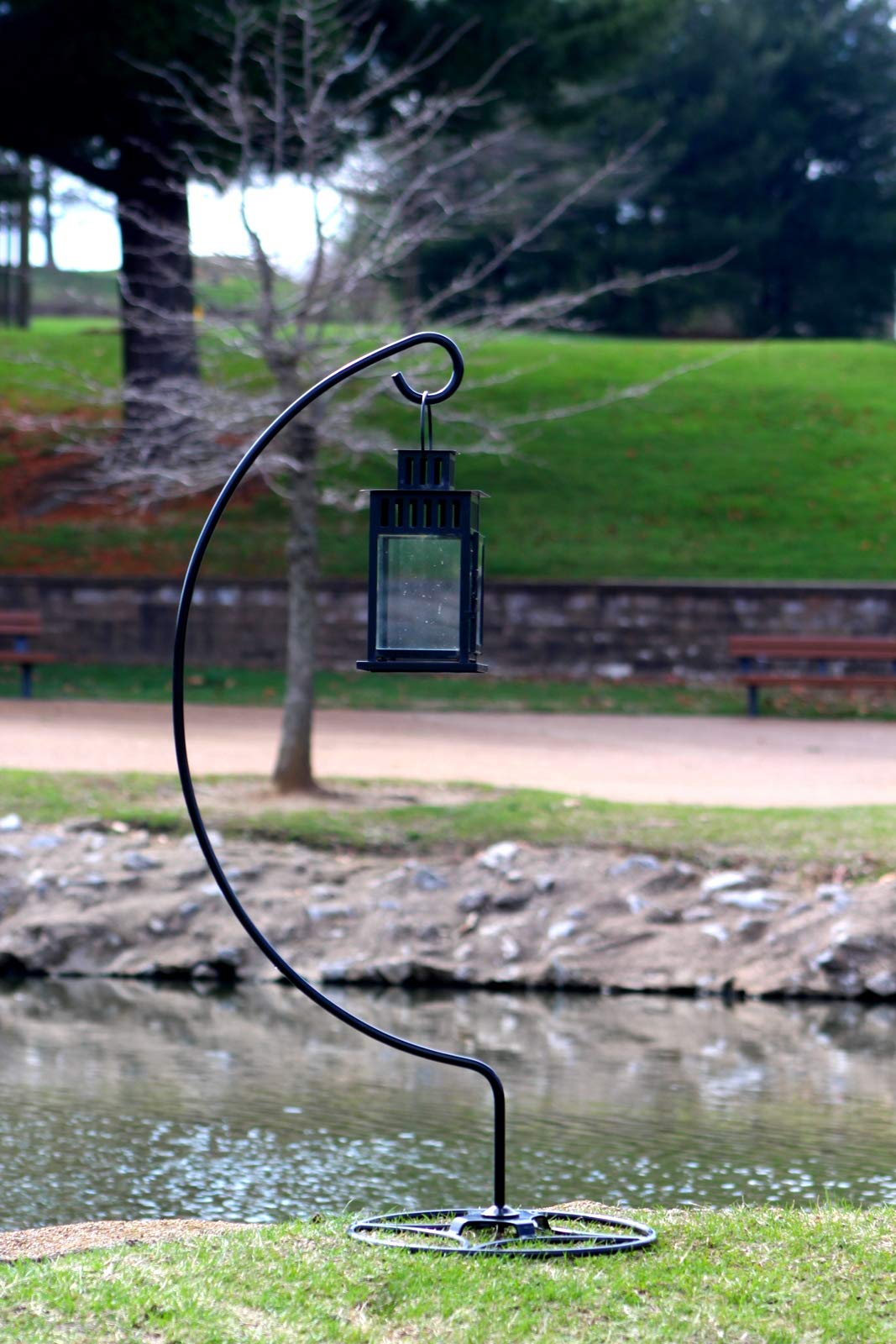 AshmanOnline shepherd hook stand holds a flower basket to brighten the patio.