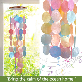 ASTARIN Capiz wind chime on garden gate provides tranquil melody