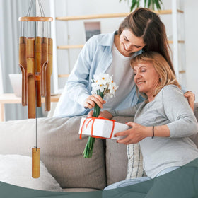 ASTARIN wind chime in natural finish showcasing the bamboo grain and rustic charm.