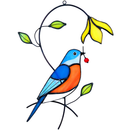 AuroAura bluebird stained glass suncatcher casting rainbow light in a sunny window.