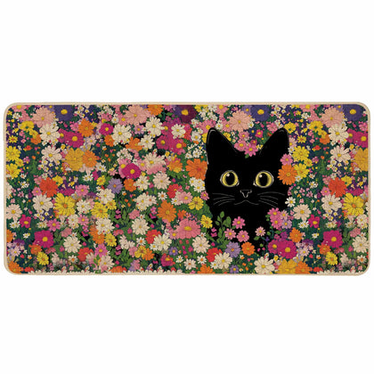 Baccessor doormat with black cat flowers welcomes guests outdoors.