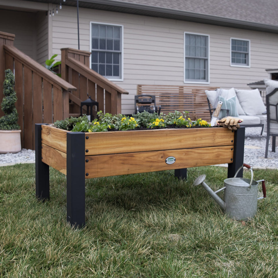 Backyard Discovery teak wood raised bed on patio highlighting durable outdoor design