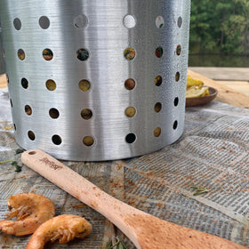 Bayou Classic fryer basket in outdoor setup boiling seafood and vegetables.