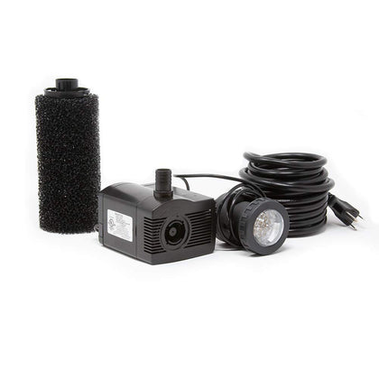 Beckett LV450T submersible pump with LED light illuminating a pond feature for nighttime ambiance.