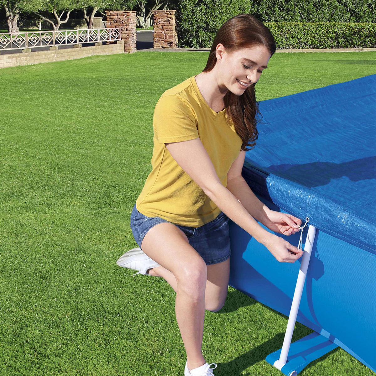 Debris-blocking design of Bestway FlowClear rectangular pool cover on a blue pool