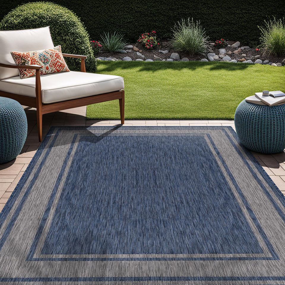 Beverly Rug outdoor rug 8x10 navy border on patio, weatherproof and easy to clean