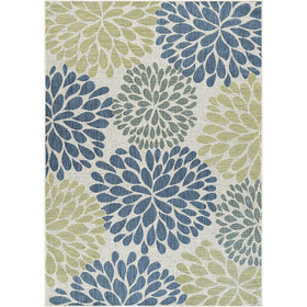 Beverly Rug tropical leaf rug arranged on a terrace for versatile indoor-outdoor styling