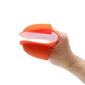 Outdoor barbecue scene with BIRDROCK HOME mitts protecting hands