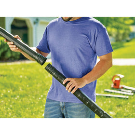 Ground-level view using the BLACK+DECKER attachment to clean gutters