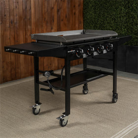 Outdoor kitchen setup featuring Blackstone 36-inch Omnivore Griddle on a patio.