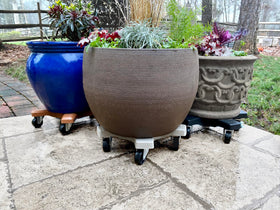 Outdoor deck setup shows Bosmere Plant Caddie in action for easy relocation.