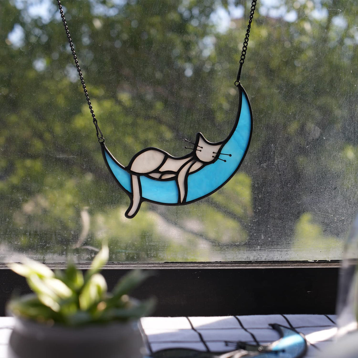BOXCASA cat on moon glass suncatcher decorates entryways with warm light.