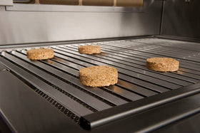 Close view of pecan bisquettes in burn chamber indicating clean, ash-free smoke.