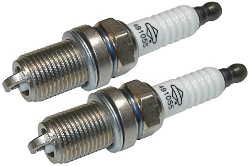 New Briggs and Stratton spark plugs installed on a small engine.