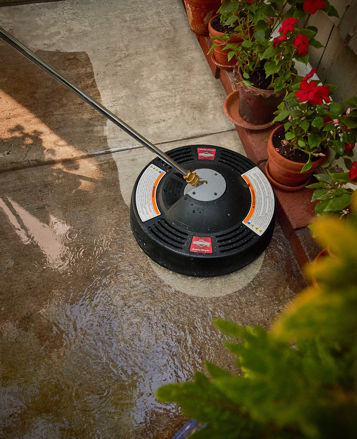 Briggs & Stratton cleaner gliding on garage floors with controlled overspray.