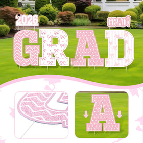 Bucherry photo backdrop yard sign creates a charming background for graduation photos.
