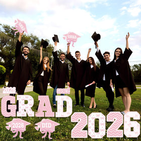 Bucherry pink bow decoration sign brings festive color to outdoor graduation celebrations.