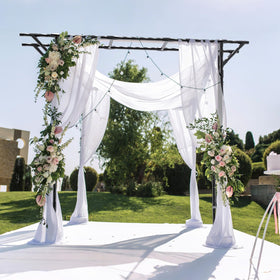 BUKLIYN Supersize Flattop Arch creates scenic outdoor wedding backdrop.