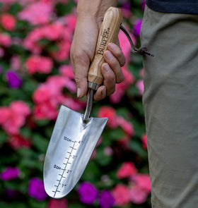 Burpee 13-inch trowel in use for precise digging and planting.