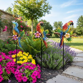 BVLFOOK Rainbow Parrot Yard Art in flower bed enhances garden charm.