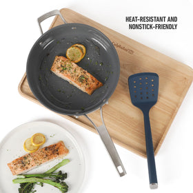 Calphalon Edge silicone slotted turner navy drains liquids while lifting pancakes and salmon.