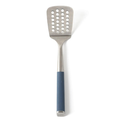 Calphalon Edge slotted turner with navy handle for precise flipping and drainage.